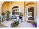 Inviting front porch with decorative plants and a bench at 1276 Bennett Pl, The Villages, FL 32162