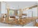 Spacious kitchen featuring granite countertops and white cabinetry at 1276 Bennett Pl, The Villages, FL 32162