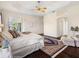 Stylish main bedroom featuring a trey ceiling, hardwood floors, and a cozy sitting area with plenty of sunlight at 1276 Bennett Pl, The Villages, FL 32162