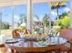 Sunroom dining arrangement on a glass table, offering natural lighting and views of the property's exterior at 1276 Bennett Pl, The Villages, FL 32162