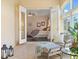 Sunroom seating area leads into bedroom, enhanced by natural lighting and views from the large windows at 1276 Bennett Pl, The Villages, FL 32162