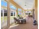 Relaxing sunroom with tile flooring, ceiling fans, and a comfortable seating area, ideal for relaxation at 1276 Bennett Pl, The Villages, FL 32162