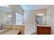 Bathroom with a large garden tub, double vanity, and neutral tones at 1350 Cavender Creek Rd, Minneola, FL 34715