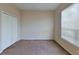 Simple bedroom with carpet, double doors and a window at 1350 Cavender Creek Rd, Minneola, FL 34715