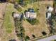 Aerial view of a home with a pool, long driveway, and surrounded by trees on a big lot at 13718 County Road 450, Umatilla, FL 32784