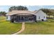 Aerial view of a home with screened-in pool and expansive yard at 13718 County Road 450, Umatilla, FL 32784