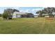 Expansive backyard with a lush lawn, a screened pool, and a scenic view at 13718 County Road 450, Umatilla, FL 32784