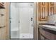 RV bathroom featuring a glass-enclosed shower, granite vanity, and modern fixtures at 13718 County Road 450, Umatilla, FL 32784