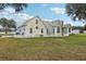 Charming home featuring a metal roof, dormer windows, and a white picket fence at 13718 County Road 450, Umatilla, FL 32784