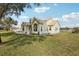 Charming home featuring a metal roof, dormer windows, and a white picket fence at 13718 County Road 450, Umatilla, FL 32784