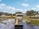 Beautiful lake view from a dock with seating, perfect for relaxing and enjoying nature in comfort at 13718 County Road 450, Umatilla, FL 32784