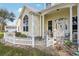 Charming home featuring a light yellow exterior, covered porch, and delightful white picket fence at 13718 County Road 450, Umatilla, FL 32784