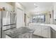 Kitchen view featuring a large center island, white cabinetry, and stainless steel refrigerator at 13718 County Road 450, Umatilla, FL 32784