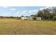 Wide shot of the buildings on the property showing open field and shed storage at 13718 County Road 450, Umatilla, FL 32784