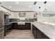 Modern kitchen with white and dark cabinets, marble counters at 1410 Conchas Dr, The Villages, FL 32162