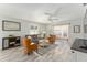 Relaxing living room with gray sofa, brown armchairs, and access to a patio at 1410 Conchas Dr, The Villages, FL 32162