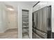 Walk-in pantry with pull-out shelving for storage at 1410 Conchas Dr, The Villages, FL 32162