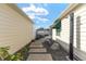 Relaxing side yard with stone pathway, outdoor shower, and landscaping at 1410 Conchas Dr, The Villages, FL 32162