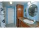 Bathroom with wood vanity, walk-in shower, and updated fixtures at 1420 Anderson St, Clermont, FL 34711