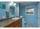 Updated bathroom with wood vanity and a modern sink at 1420 Anderson St, Clermont, FL 34711