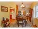 Bright dining room with wooden table and chairs, kitchen view at 1420 Anderson St, Clermont, FL 34711