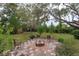 Charming fire pit area with brick border and checkered patio at 1420 Anderson St, Clermont, FL 34711