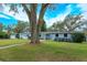 Charming light blue house with large tree and spacious yard at 1420 Anderson St, Clermont, FL 34711