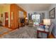 Living room with wood-paneled accent wall and access to deck at 1420 Anderson St, Clermont, FL 34711