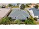 Aerial view of a house showing the roof, screened enclosure, and surrounding landscape at 1548 Loris Loop, The Villages, FL 32162