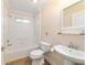 Clean bathroom with a tub, toilet, and sink at 1548 Loris Loop, The Villages, FL 32162