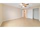 Well-lit bedroom with tile floors and ceiling fan at 1548 Loris Loop, The Villages, FL 32162