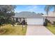 Neatly landscaped front yard with paver driveway at 1548 Loris Loop, The Villages, FL 32162