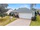 Attractive front yard with paver driveway and landscaping at 1548 Loris Loop, The Villages, FL 32162