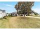 Landscaped yard with large tree and spacious lawn at 1548 Loris Loop, The Villages, FL 32162