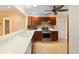 Modern kitchen with wood cabinets and stainless steel appliances at 1548 Loris Loop, The Villages, FL 32162