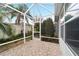 Spacious screened patio with paver stones and access to backyard at 1548 Loris Loop, The Villages, FL 32162