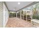 Enclosed porch with paver floor and ceiling fan at 1548 Loris Loop, The Villages, FL 32162