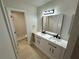 Updated bathroom with double vanity and large mirror at 1562 Lawndale Cir, Winter Park, FL 32792