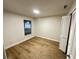 Bright bedroom with light wood laminate flooring and a white closet at 1562 Lawndale Cir, Winter Park, FL 32792