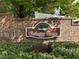 Close-up of a brick entrance sign with colorful landscaping at 1562 Lawndale Cir, Winter Park, FL 32792