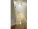 Hallway with glossy tile flooring leading to a bathroom at 1562 Lawndale Cir, Winter Park, FL 32792