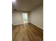 Hallway with wood floors leading to a bathroom at 1562 Lawndale Cir, Winter Park, FL 32792