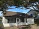 Rear view of house with screened porch and large tree at 1562 Lawndale Cir, Winter Park, FL 32792