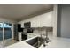 Well-lit kitchen with stainless steel appliances and white cabinetry at 1562 Lawndale Cir, Winter Park, FL 32792