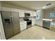 Open kitchen layout featuring stainless steel appliances and a seamless flow at 1562 Lawndale Cir, Winter Park, FL 32792