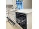 Modern kitchen island with white quartz countertop and stainless steel dishwasher at 1562 Lawndale Cir, Winter Park, FL 32792