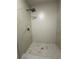 Walk-in shower with marble-look walls and tiled floor at 1562 Lawndale Cir, Winter Park, FL 32792