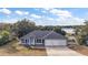 Three-car garage house exterior with lake view at 16029 Worthington N Blvd, Mascotte, FL 34753