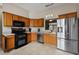 Modern kitchen with stainless steel appliances and wood cabinets at 16029 Worthington N Blvd, Mascotte, FL 34753