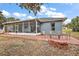 Screened patio with brick pavers, fire pit, and outdoor seating at 16029 Worthington N Blvd, Mascotte, FL 34753